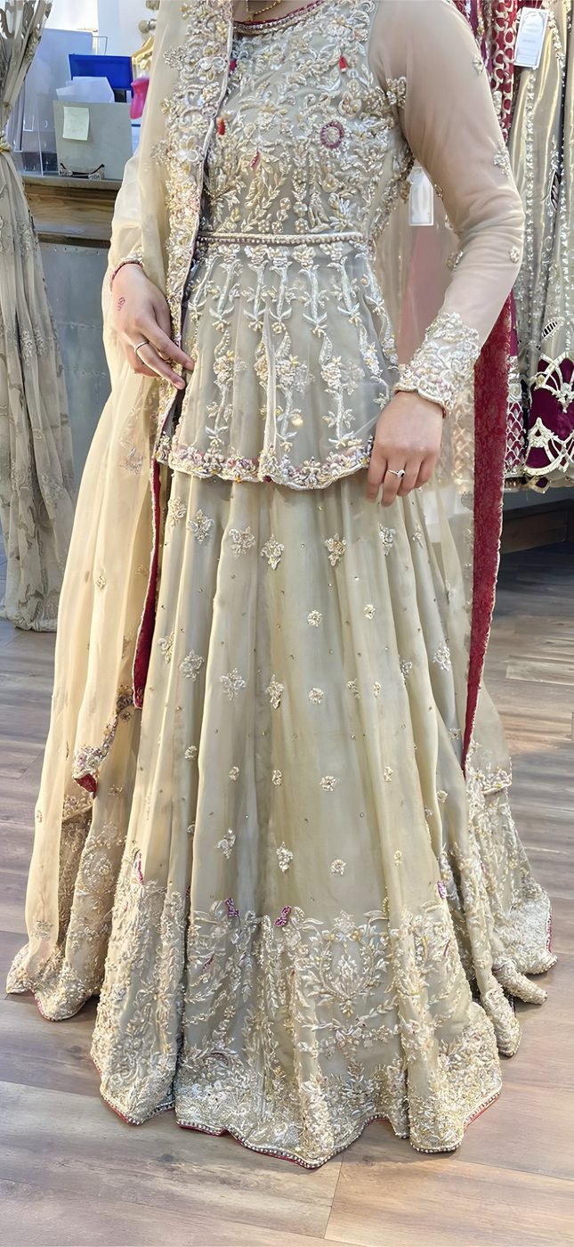 Gold pearl-embroidered bridal skirt detail, worn with henna-decorated hands