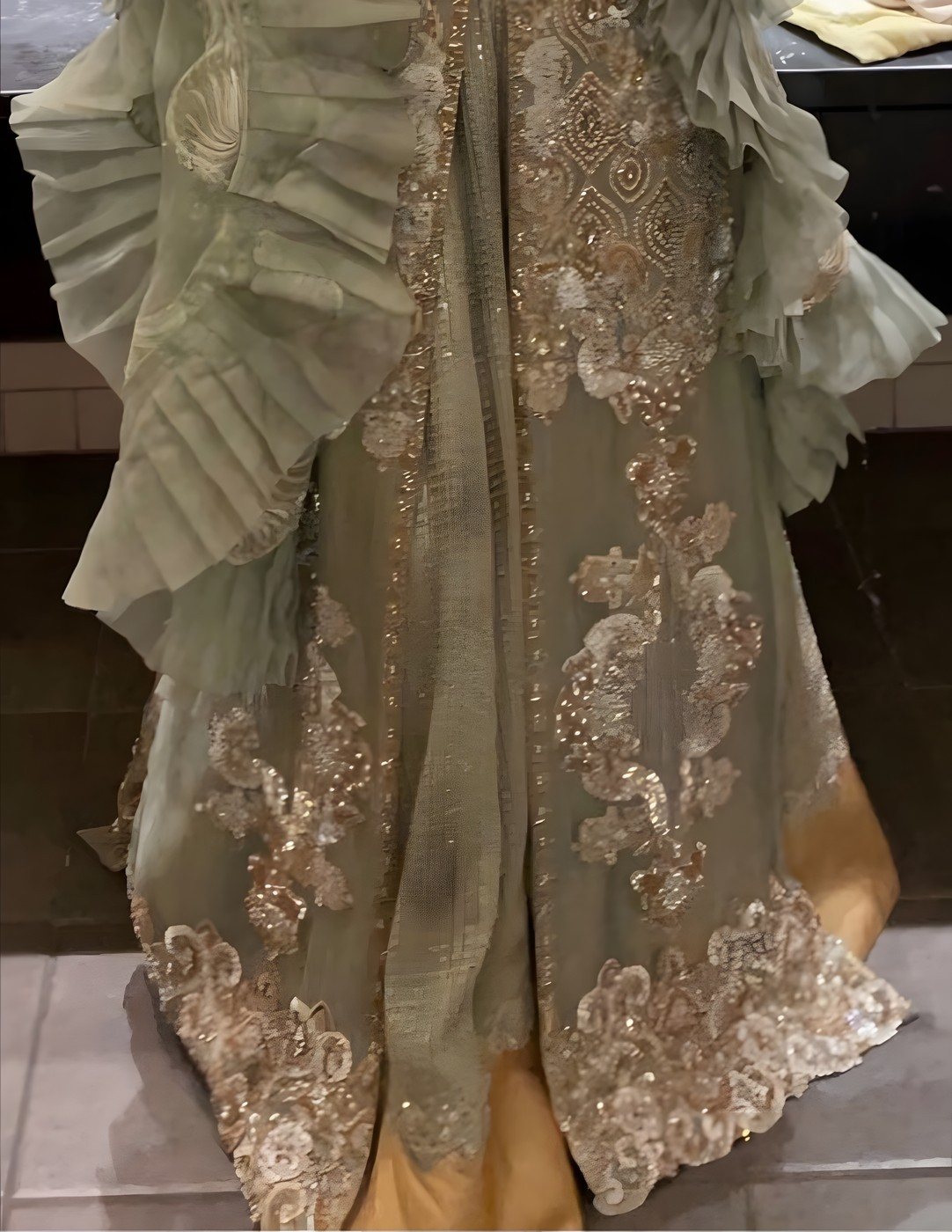 Sage green heavily embroidered occasion outfit with ruffled organza sleeves
