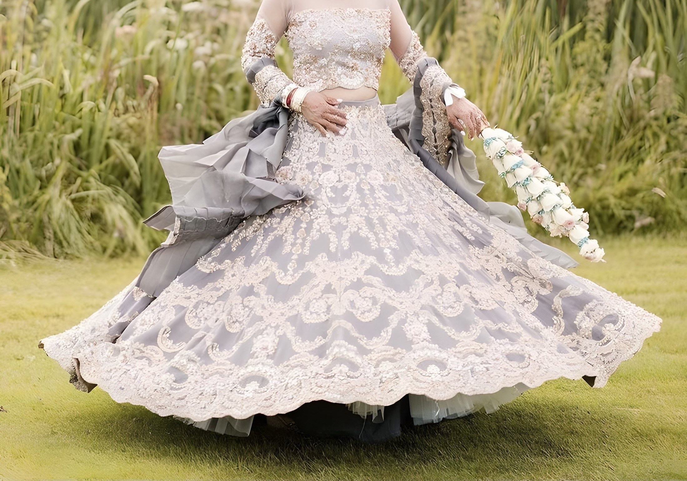 Bride wearing a hand-embroidered grey and silver Tehxeeb London lehenga, photographed outdoors